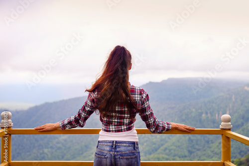 Beautiful brunette woman in mountains