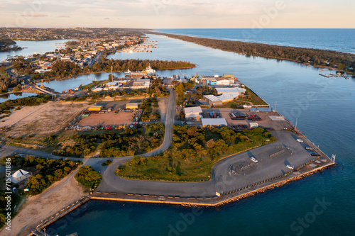 Aerial view of an industrial area and carpark on an island near a coastal community photo