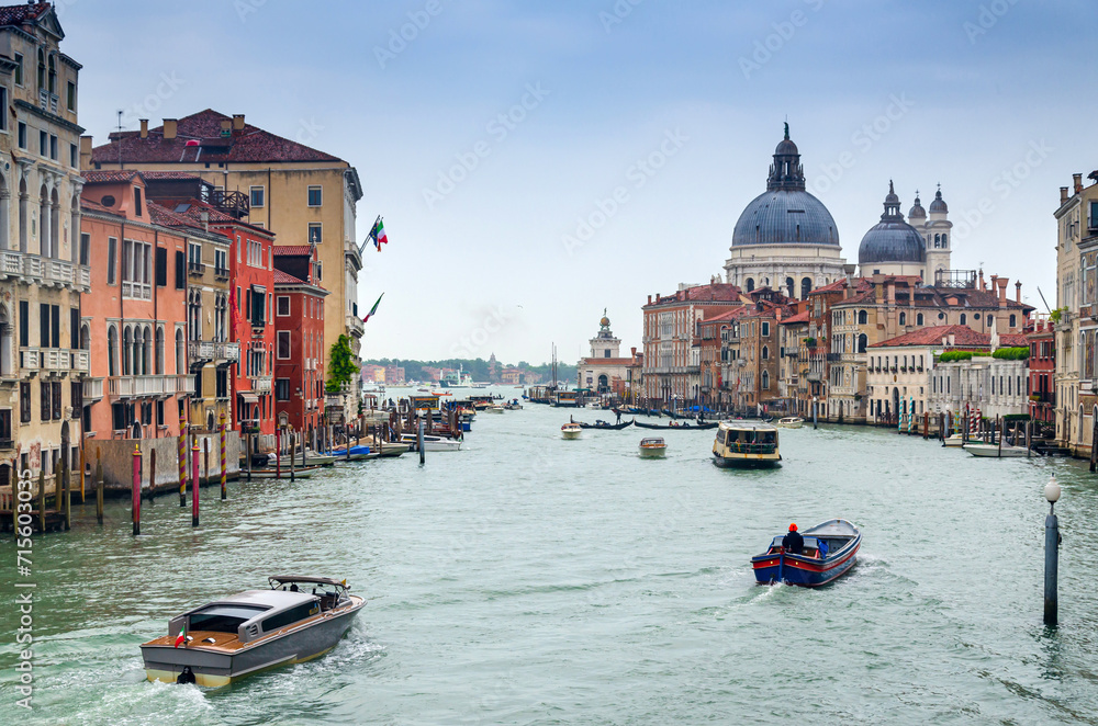 Grand canal in Venice, Italy, with divine Santa Maria della Salute church domintaing in the cityscape
