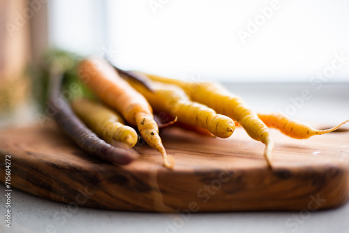 close up of carrot tips on a chopping board photo