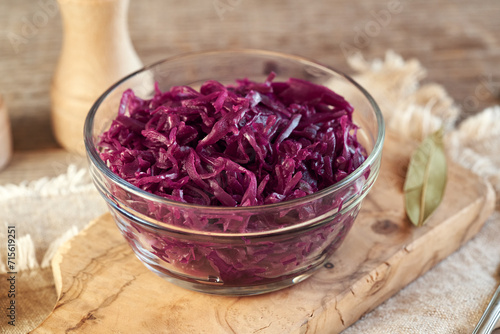 Purple fermented cabbage or sauerkraut in a transparent glass bowl