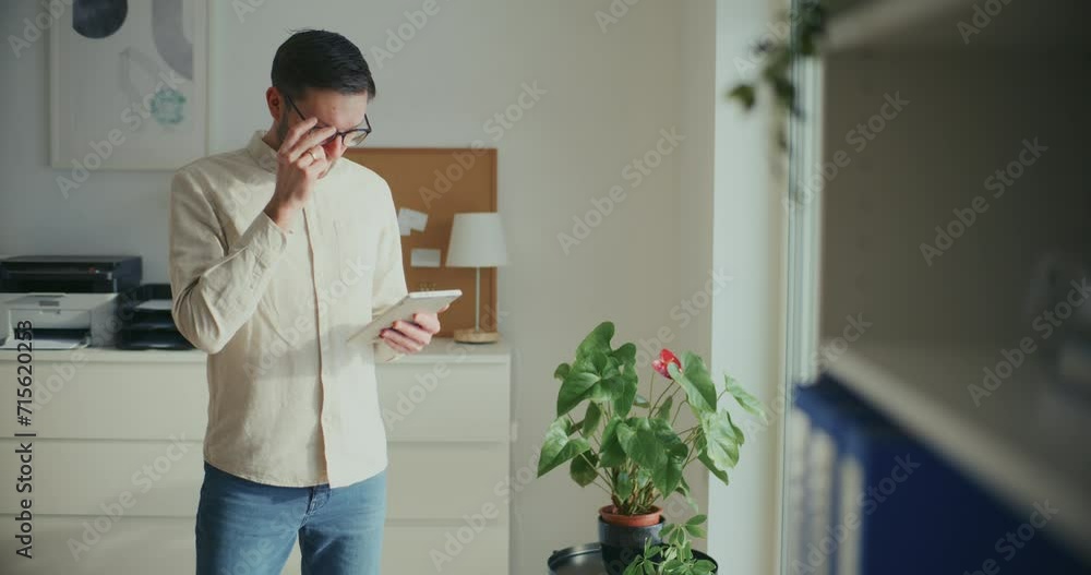 Contemplative Businessman Working On Digita Tablet In Office Contemplative Businessman Working On Digita Tablet In Office