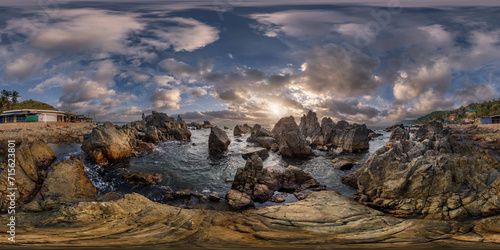 full hdri 360 panorama view on ocean on shore with rocks at sunset with beautiful clouds in sky in equirectangular projection with zenith and nadir. VR AR content