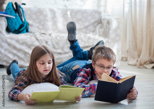 Children readind book in living room photo