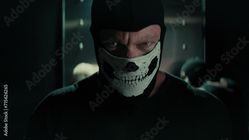 Bank robber with a skull mask looking at the camera photo