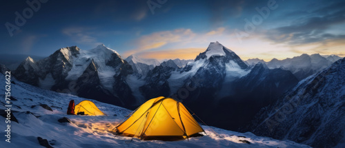 Panorama of Steep peak mountains with covered snow and yellow tent camping at twilight time.