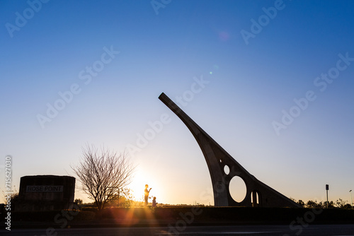 Silhouette sundial in singleton with tourist mother and child photo