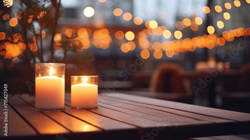 Lit up candle at an outdoor table of a restaurant in winter, cosy atmosphere, selective focus, bokeh. photo