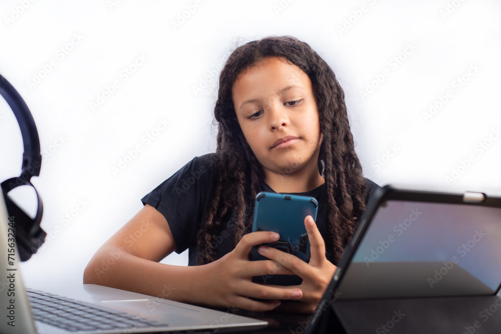 Teenage Brazilian woman using technology, white background, selective focus. Teenage Brazilian woman using technology, white background, selective focus.