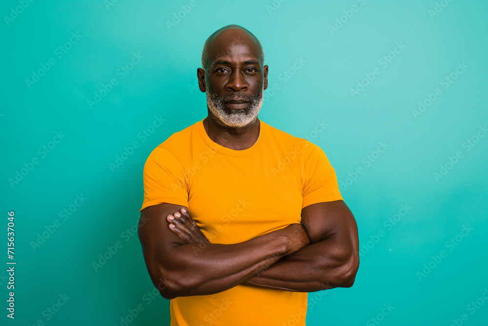 Portrait african athletic attractive serious middle aged man on a bright light blue background. Portrait african athletic attractive serious middle aged man on a bright light blue background.
