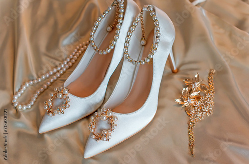 Weddings women white shoes with a heels with a flowers and pearls. Concept of Wedding, accessorize