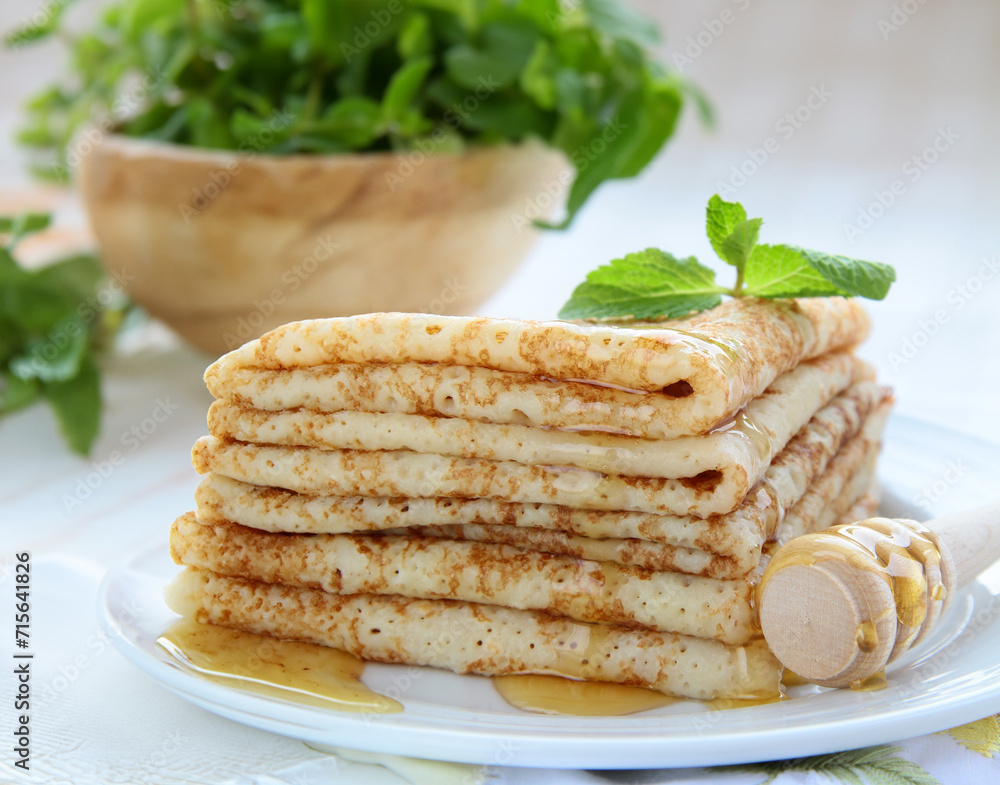 thin French crepe pancakes with fresh berries and honey thin French crepe pancakes with fresh berries and honey