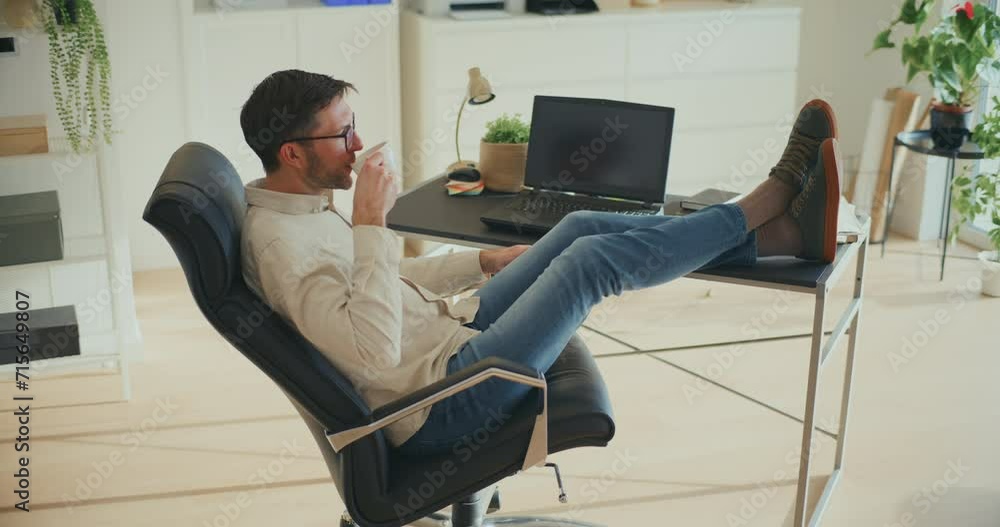 Businessman Talking On Mobile Phone While Sitting On Chair Businessman Talking On Mobile Phone While Sitting On Chair