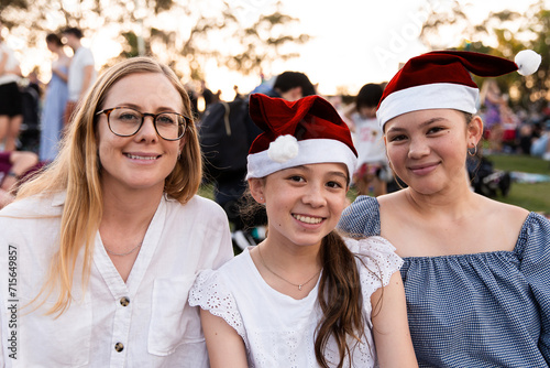 mother and her teenage daughters at a Christmas community event photo