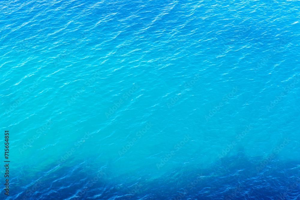 Ripple of blue sea water. Textured sea water background. Top view.