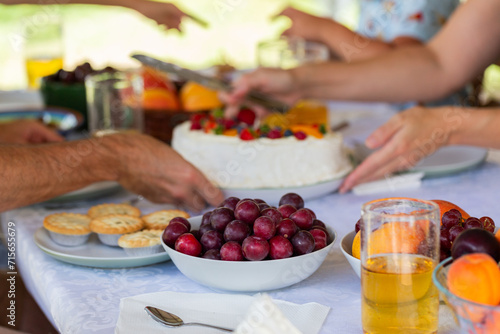 Bowl of fresh organic sugarplum fruits in bowl on Christmas lunch dessert table
