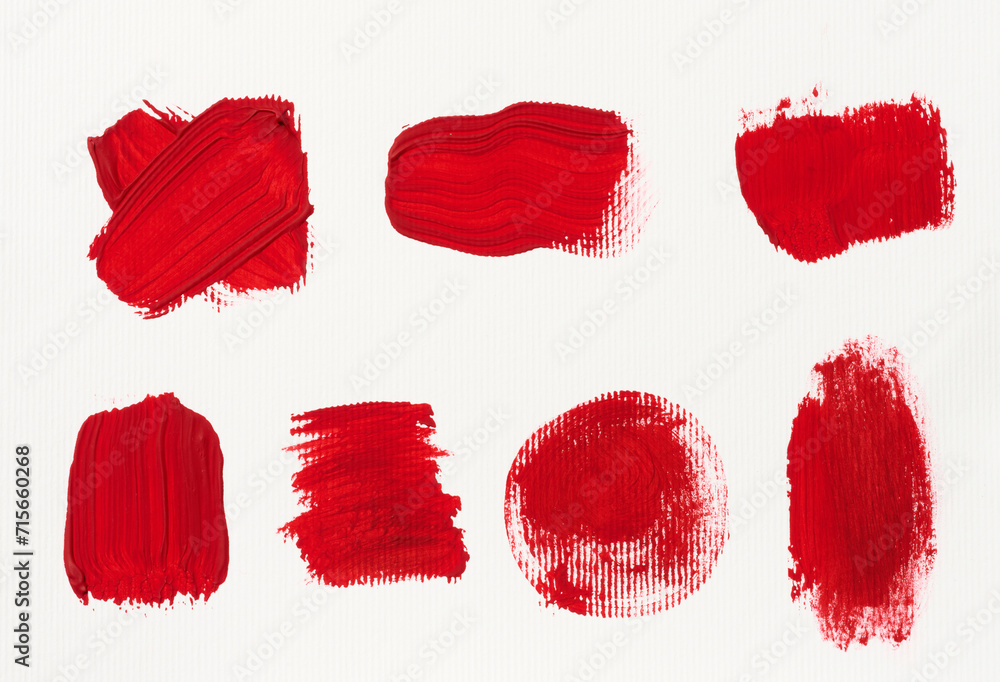 Various strokes of red gouache paint on a white sheet of paper - obrazy, fototapety, plakaty 