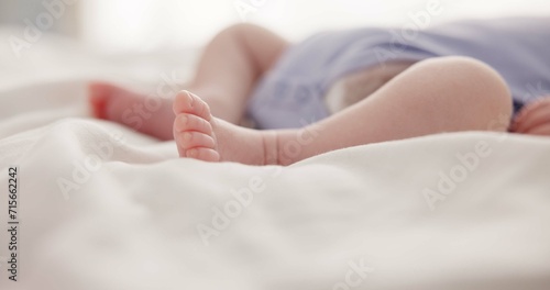 Sleeping, dreaming and feet of baby on bed for child care, resting and relax in nursery. Adorable, cute and closeup of toes of innocent newborn infant for health, wellness and development at home