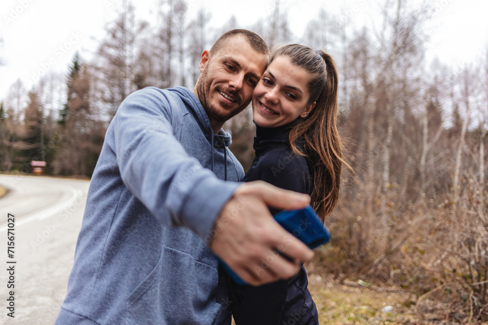 Fitness and selfie with couple in nature together for health, wellness and exercise. Smile, motivation and sports training with young man and woman for workout, running and happy. Fitness and selfie with couple in nature together for health, wellness and exercise. Smile, motivation and sports training with young man and woman for workout, running and happy.