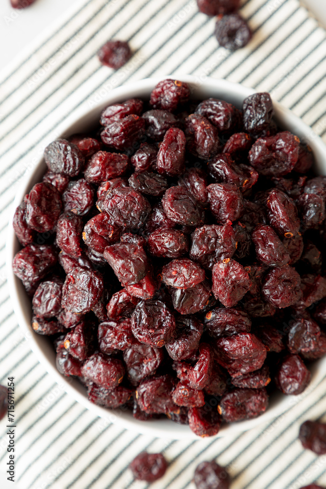 Organic Dried Cranberries in a Bowl, top view. Flat lay, overhead, from above. Close-up. Organic Dried Cranberries in a Bowl, top view. Flat lay, overhead, from above. Close-up.