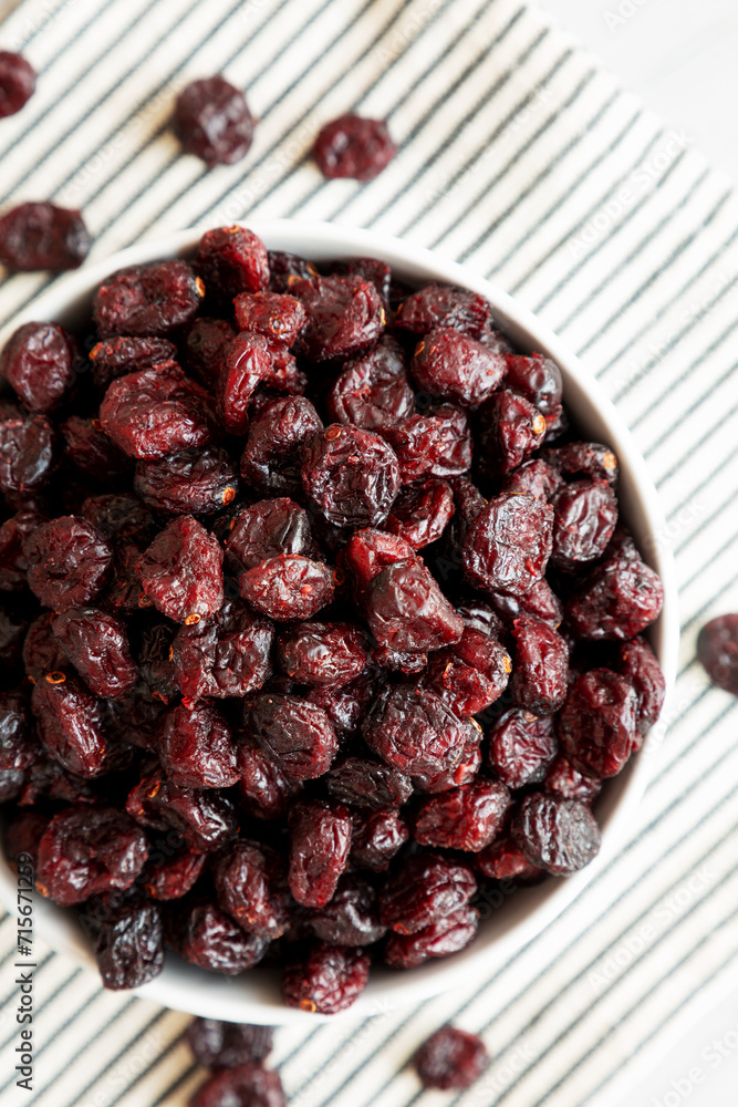 Organic Dried Cranberries in a Bowl, top view. Flat lay, overhead, from above. Organic Dried Cranberries in a Bowl, top view. Flat lay, overhead, from above.