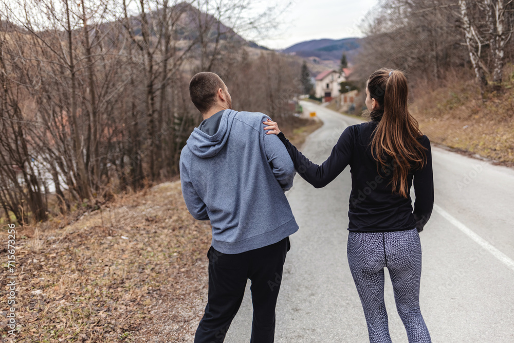 Happy athletic couple having fun while running in autumn day.