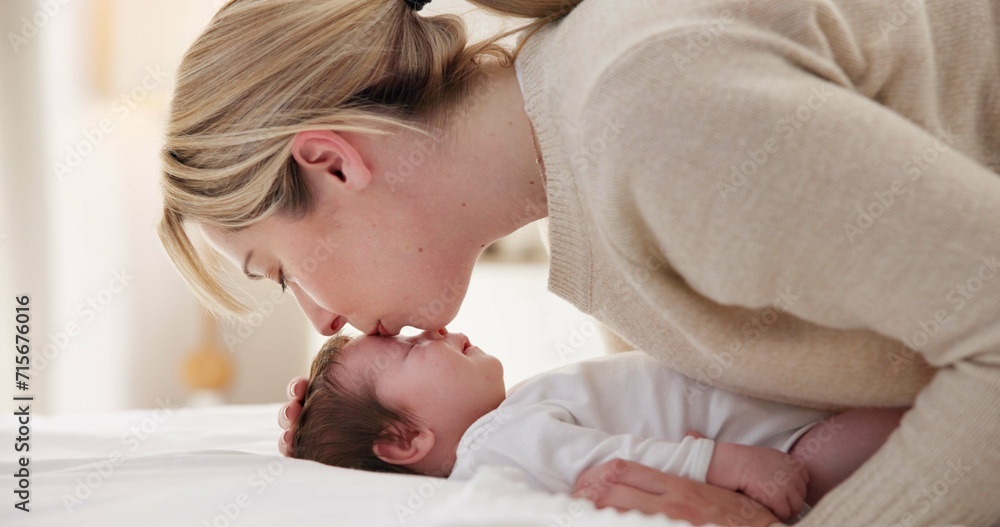 Happy, mother and baby kiss with love, care and support in a home with newborn and bonding. Morning, mom and relax infant with child security and motherhood in a family home on a bed with mama Happy, mother and baby kiss with love, care and support in a home with newborn and bonding. Morning, mom and relax infant with child security and motherhood in a family home on a bed with mama
