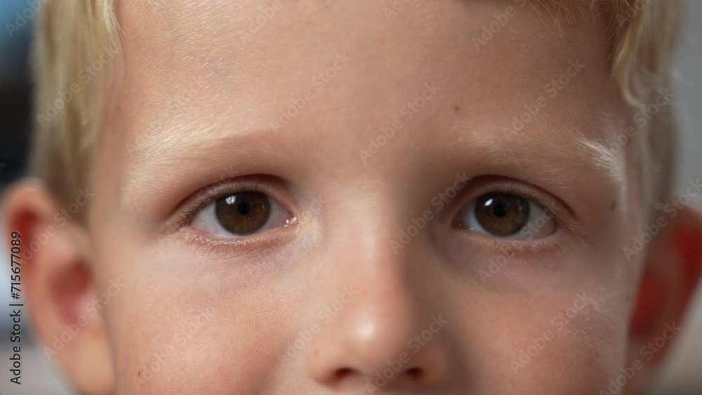 Close-up of a cute small caucasian boy's face blinking, with beautiful dark eyes looking directly into the camera. Slow motion. High quality 4k footage. Close-up of a cute small caucasian boy's face blinking, with beautiful dark eyes looking directly into the camera. Slow motion. High quality 4k footage.