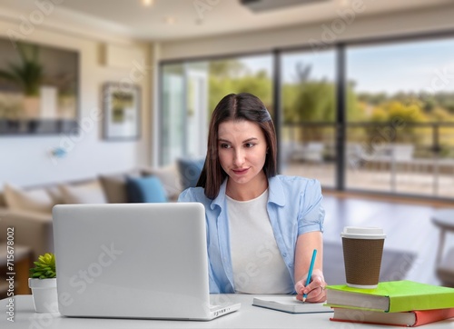 Happy woman using computer while working from home