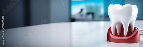 Close-up of tooth in front of dental office on blurred background with a place for text. Modern Dental Clinic in blue medical light. Copy space. Healthcare and medicine