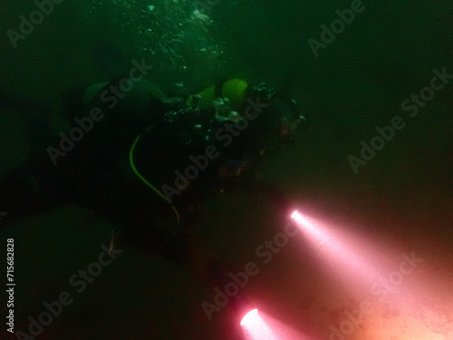 Scuba divers in a merky lake in Switzerland