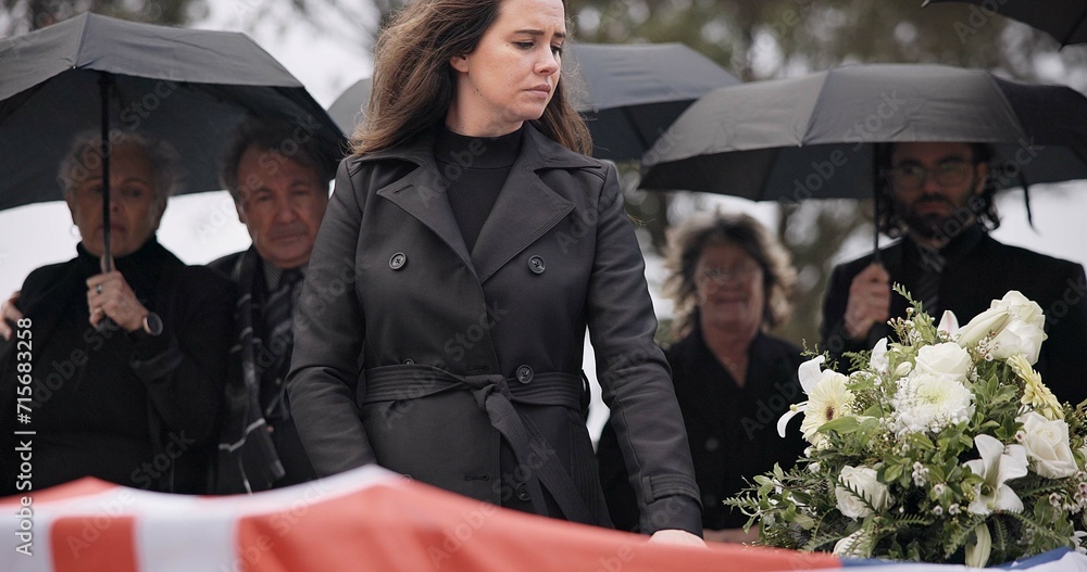 Obraz premium USA veteran funeral, woman and sad to touch casket, family and flag with mourning, depression and respect. Widow, people and army service with coffin, burial and crying for war hero in Philadelphia