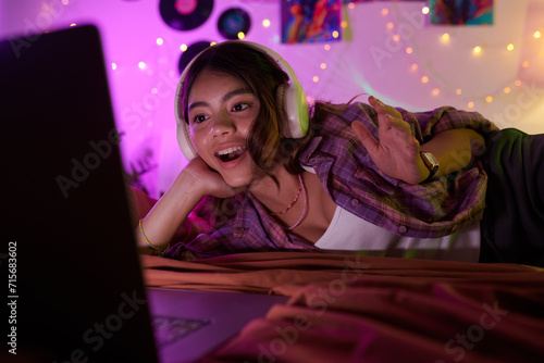 Excited girl watching her favorite video on laptop