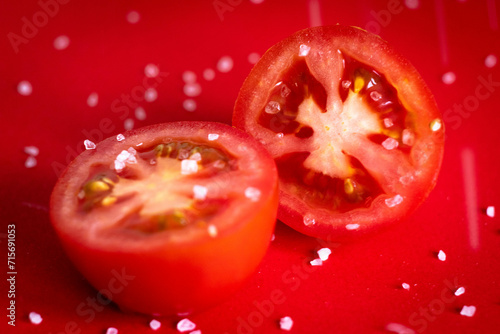 Tomatoes being sprinkled with salt.  © Sandie
