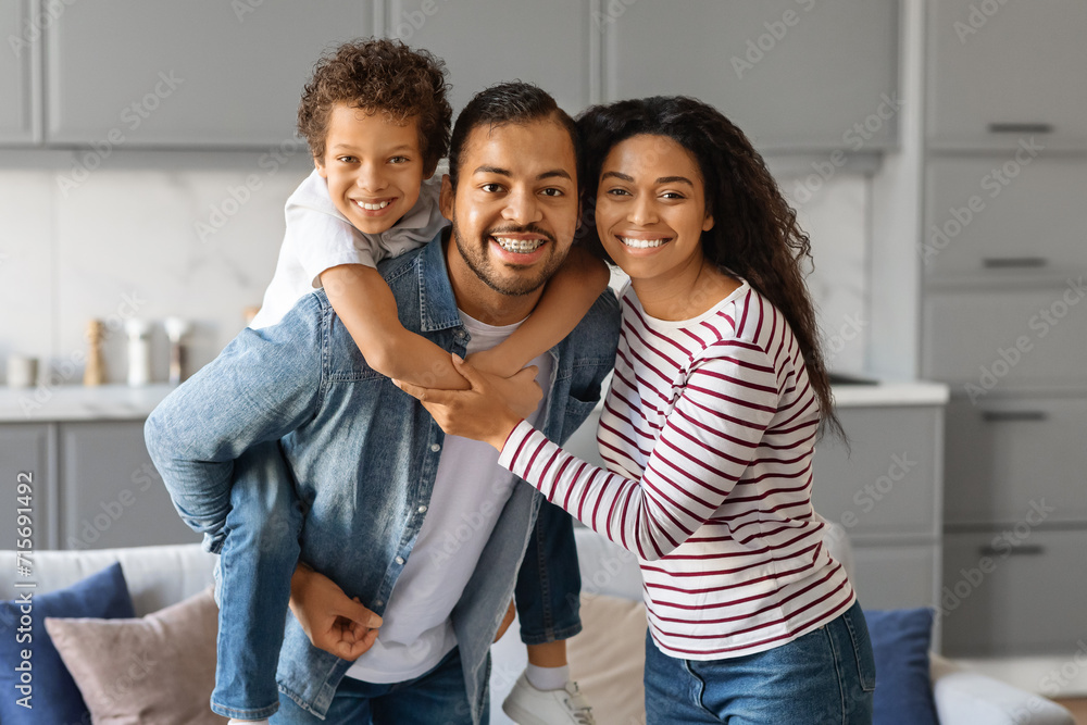 Portrait Of Happy African American Family Of Three Posing Together At Home
