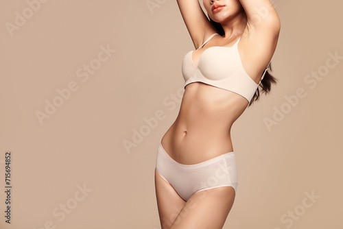 Confident beautiful young asian woman posing in white lingerie on beige background, Perfect body,
