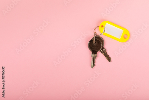 Plastic key ring in different colors with a place for a signature on a bright colored background. Bunch of keys with keychain. Mock-up keychain.Copy space.Concept for renting and selling real estate. photo