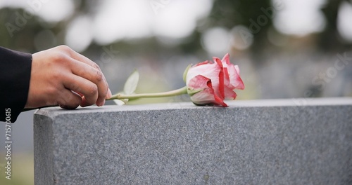 Fotografie Funeral, cemetery and hands with rose on tombstone for remembrance, ceremony and memorial service