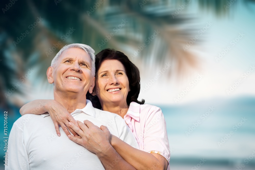 Obraz premium Happy senior couple have fun at the beach at vacation