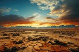 As the fiery sun rises over the rugged mountains, casting vibrant colors across the desert sky, the parched ground below stands as a reminder of the harsh yet captivating ecoregion that thrives in th