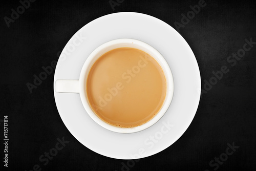 Tea Cup filled with plate on isolated black textured background. Soothing Cup of Tea on a Elegant Black Isolated Backdrop