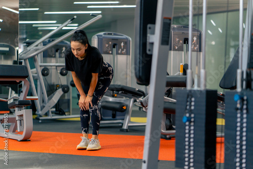 young girl in sportswear in the gym doing leg exercises before training healthy lifestyle