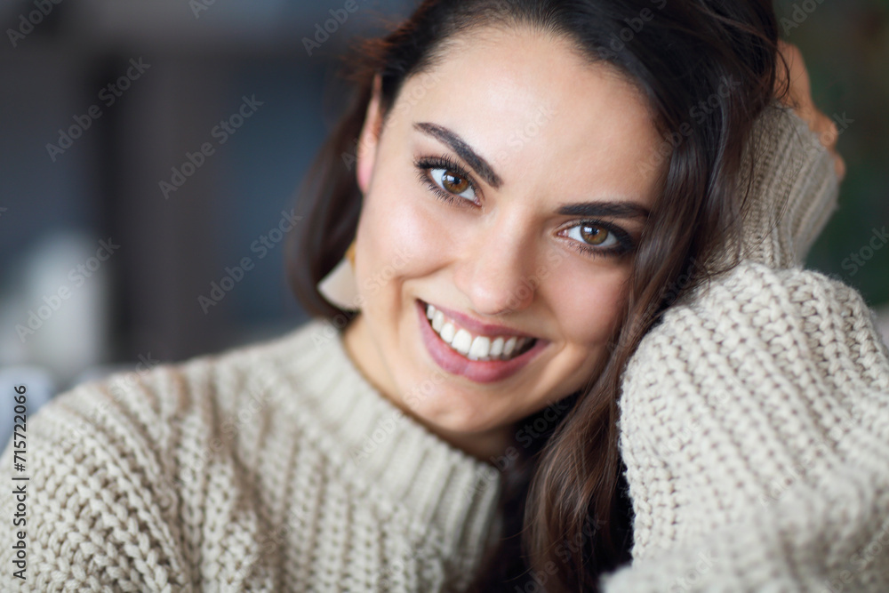 Portrait of a young happy beautiful woman in warm clothings at home Portrait of a young happy beautiful woman in warm clothings at home