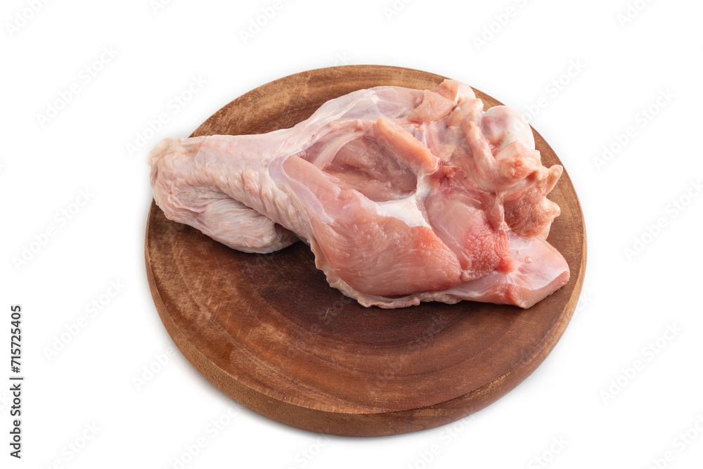 Raw turkey wing on a wooden cutting board isolated on white. Side view.