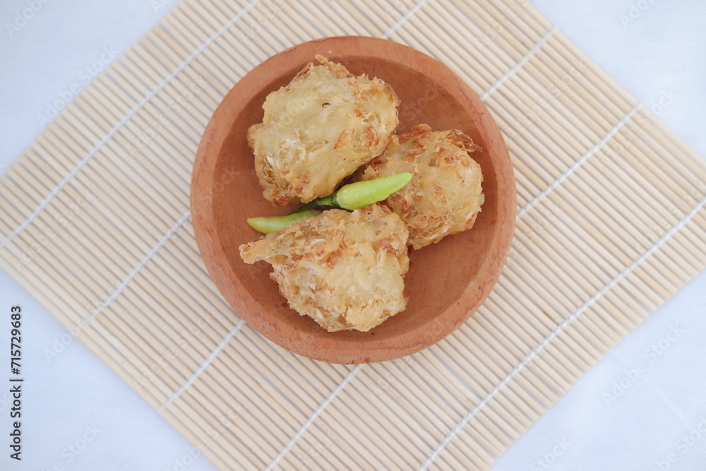 Bakwan sayur or vegetable fritter, Indonesian snack made from flour, cabbage, carrots and bean sprouts, served with chili