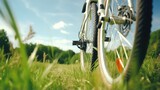 A close-up of a bicycle wheel in a forest clearing in the summer. Active lifestyle. Illustration for cover, card, postcard, interior design, banner, poster, brochure or presentation.