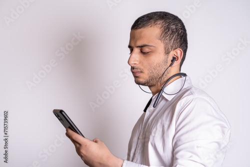 Isolated image of bearded middle eastern business man working on smartphone. © Sina