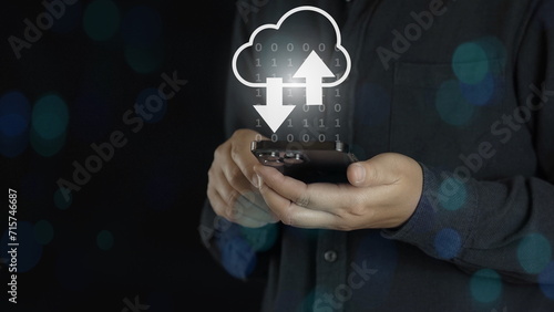 Businessman using smartphone with virtual cloud computing technology for uploading and downloading information data concept.