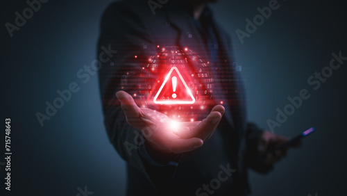 Warning alert icon with a hacked system. malicious software, virus, spyware, malware, or cyberattacks on computer networks. Security on the internet and online scam. Digital data is being compromised. photo