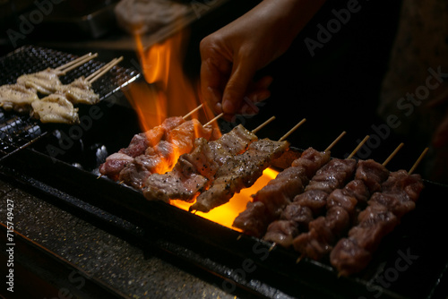 Slika na platnu Grilled yakitori chicken skewers at an Izakaya restaurant in Omoide Yokocho street in the Shinjuku district of Tokyo